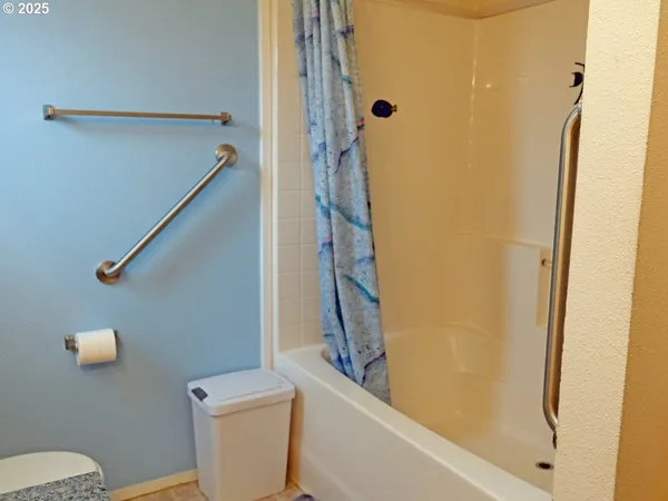 a bathroom with a shower and a toilet