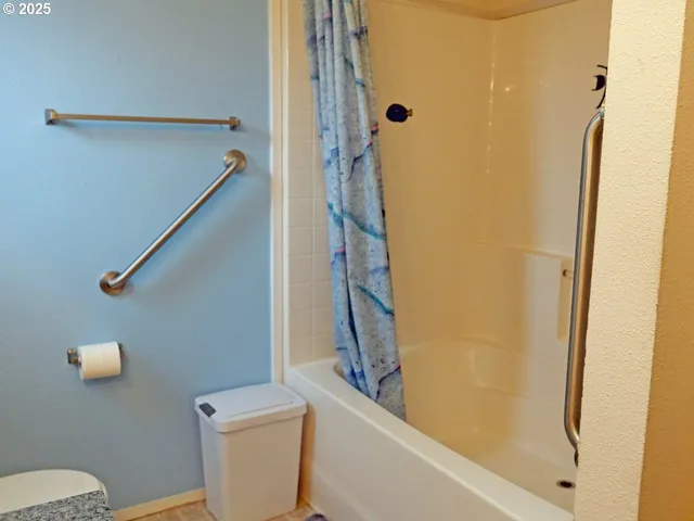 a bathroom with a shower and a toilet