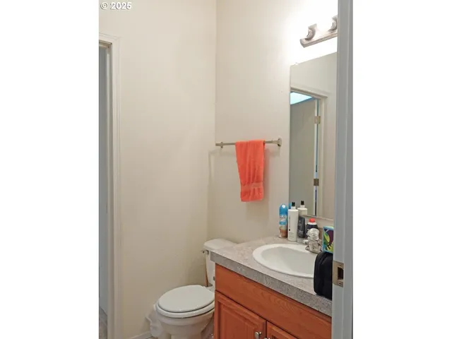a bathroom with a sink toilet vanity and mirror
