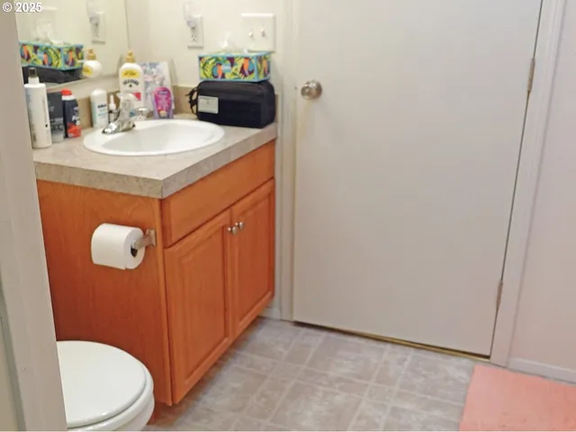 a bathroom with a sink a toilet and mirror