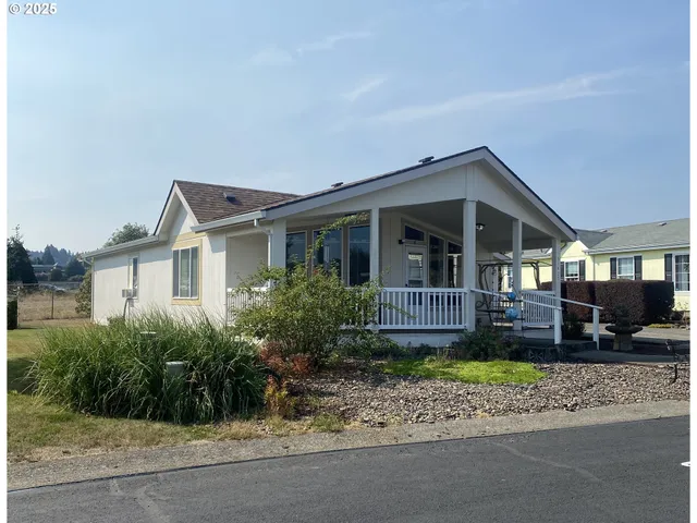 a front view of a house with a garden and plants