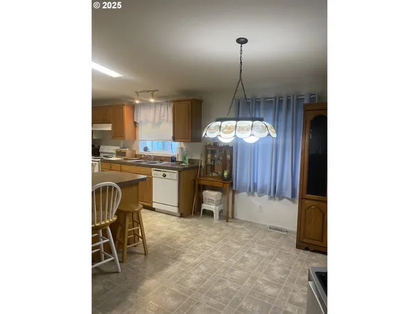 a kitchen with kitchen island a counter top space appliances and cabinets