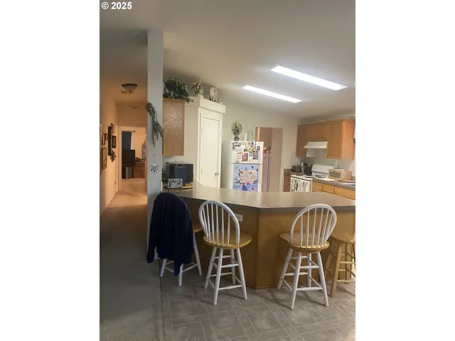 a dining room with furniture and a chandelier