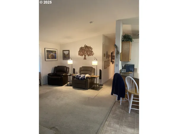 a living room with furniture and a lamp