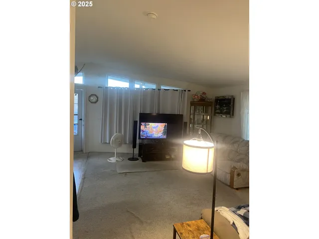 a view of a hallway with two windows