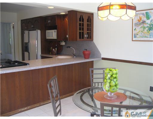 3 Fielding Place Edison, NJ 08820 - Photo 11 of 25 a kitchen with a table and a chair