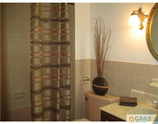3 Fielding Place Edison, NJ 08820 - Photo 13 of 25 a bathroom with a sink and a mirror