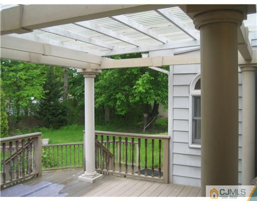 3 Fielding Place Edison, NJ 08820 - Photo 23 of 25 a view of a backyard with a large window and wooden fence