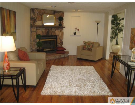 3 Fielding Place Edison, NJ 08820 - Photo 8 of 25 a living room with furniture and a fireplace