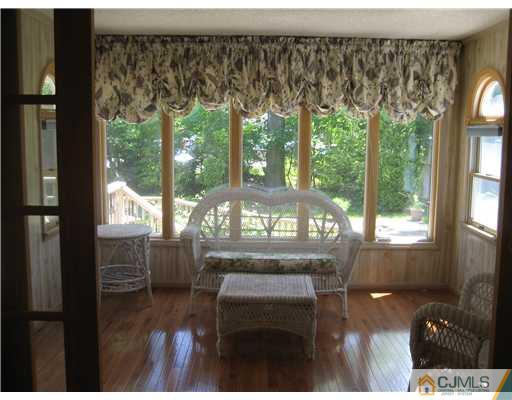 3 Fielding Place Edison, NJ 08820 - Photo 9 of 25 a view of a porch with furniture and wooden floor