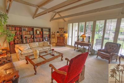 72025 Petunia Way Rancho Mirage, CA 92270 - Photo 1 of 18 a living room with furniture and a floor to ceiling window