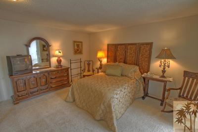 72025 Petunia Way Rancho Mirage, CA 92270 - Photo 14 of 18 a bed room with furniture and mirror
