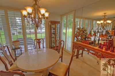 72025 Petunia Way Rancho Mirage, CA 92270 - Photo 9 of 18 a dining room with furniture a chandelier and floor to ceiling windows