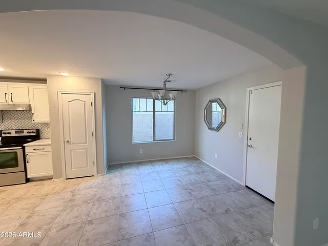 a view of a kitchen with a sink and refrigerator