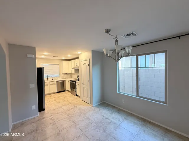 a kitchen with a refrigerator sink and cabinets