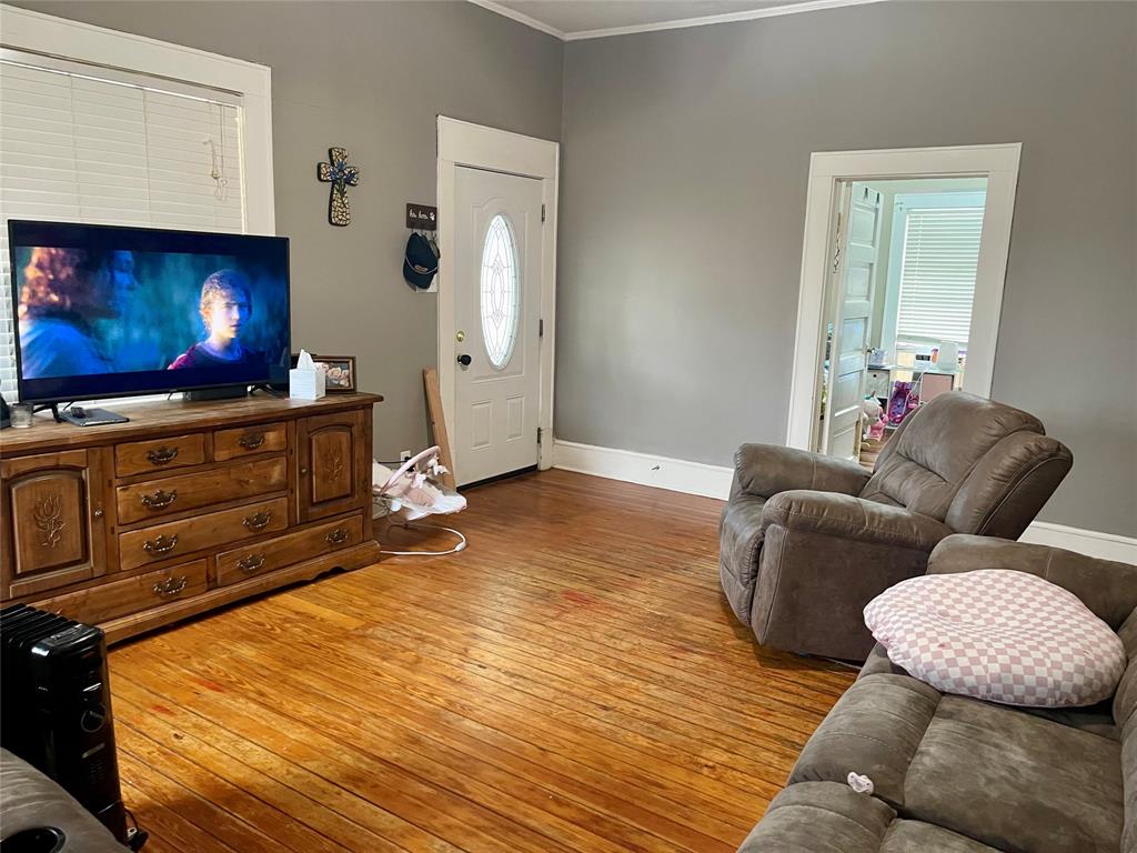 1023 North Spring Street Grand Saline, TX 75140 - Photo 6 of 39 a living room with furniture and a flat screen tv