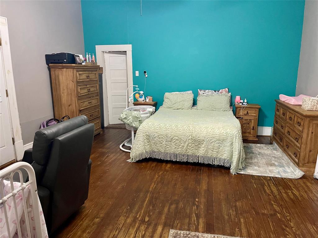 1023 North Spring Street Grand Saline, TX 75140 - Photo 8 of 39 a bedroom with a bed and wooden floor