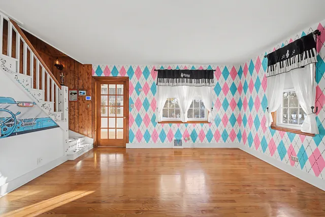 wooden floor in an empty room with a window