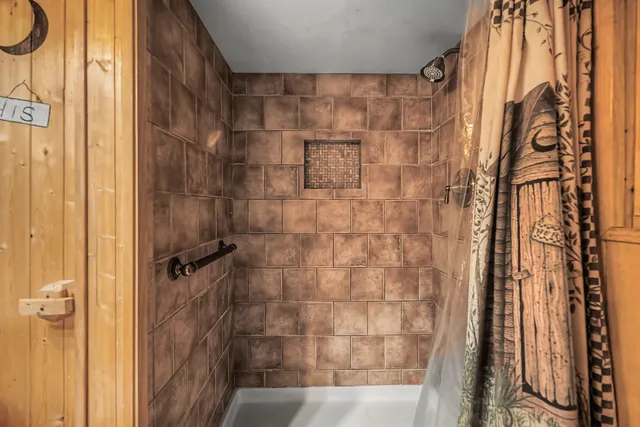 a walk in closet with wooden floor