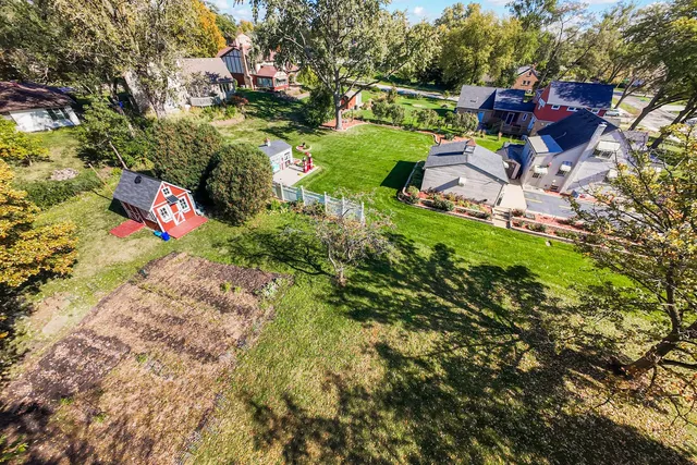 an aerial view of a house with a yard basket ball court and outdoor seating
