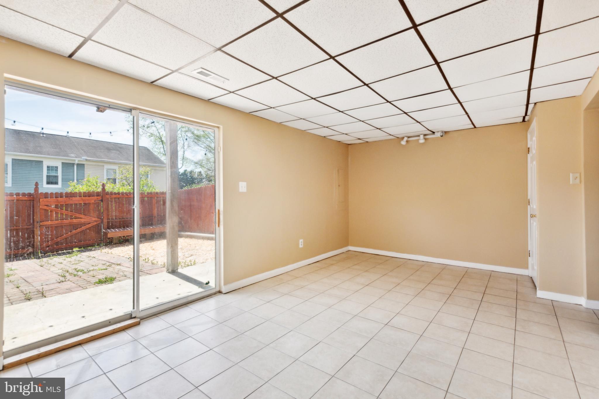 795 St Michaels Drive Bowie, MD 20721 - Photo 17 of 25 a view of empty room with wooden floor and iron fence