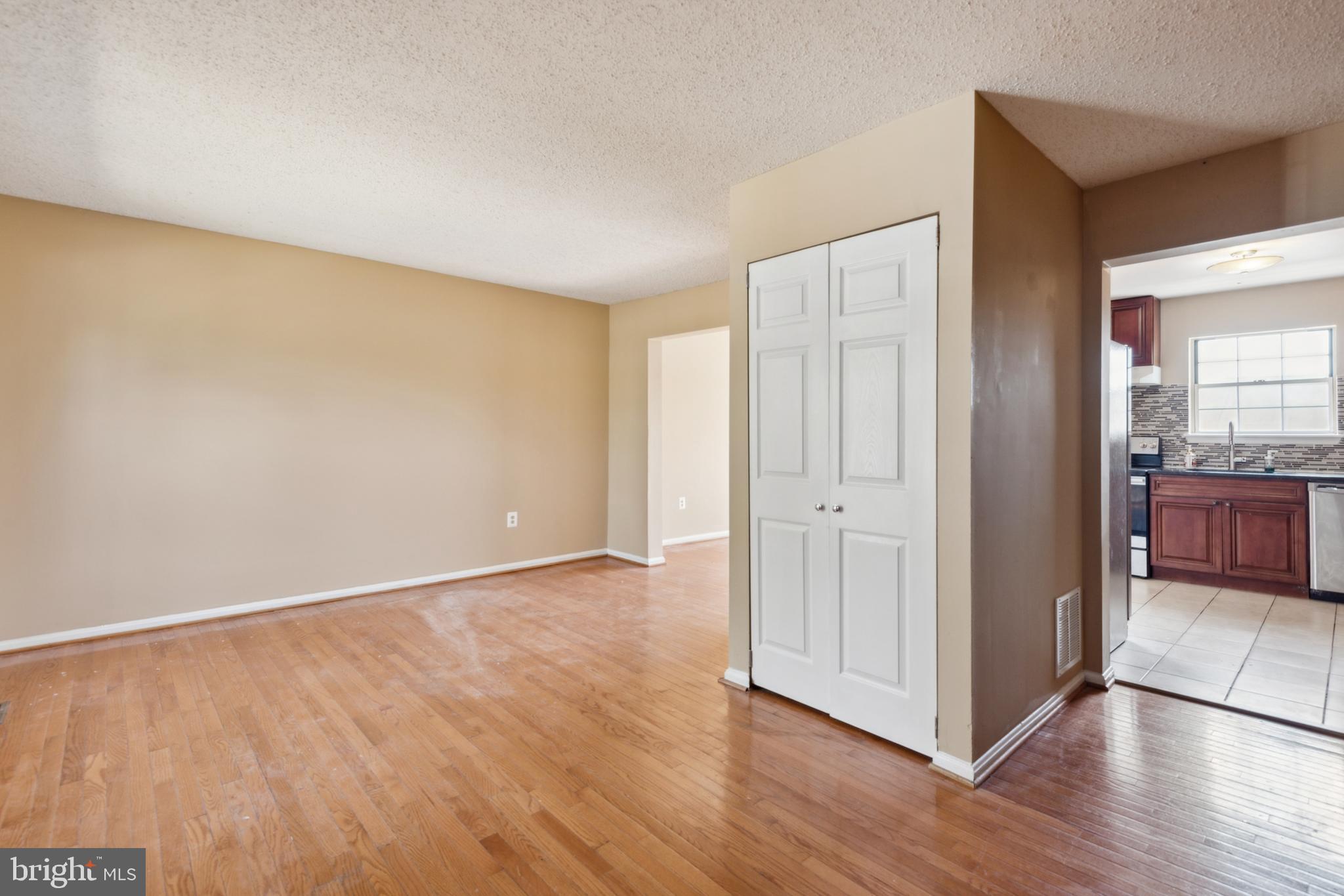 795 St Michaels Drive Bowie, MD 20721 - Photo 2 of 25 an empty room with wooden floor and windows
