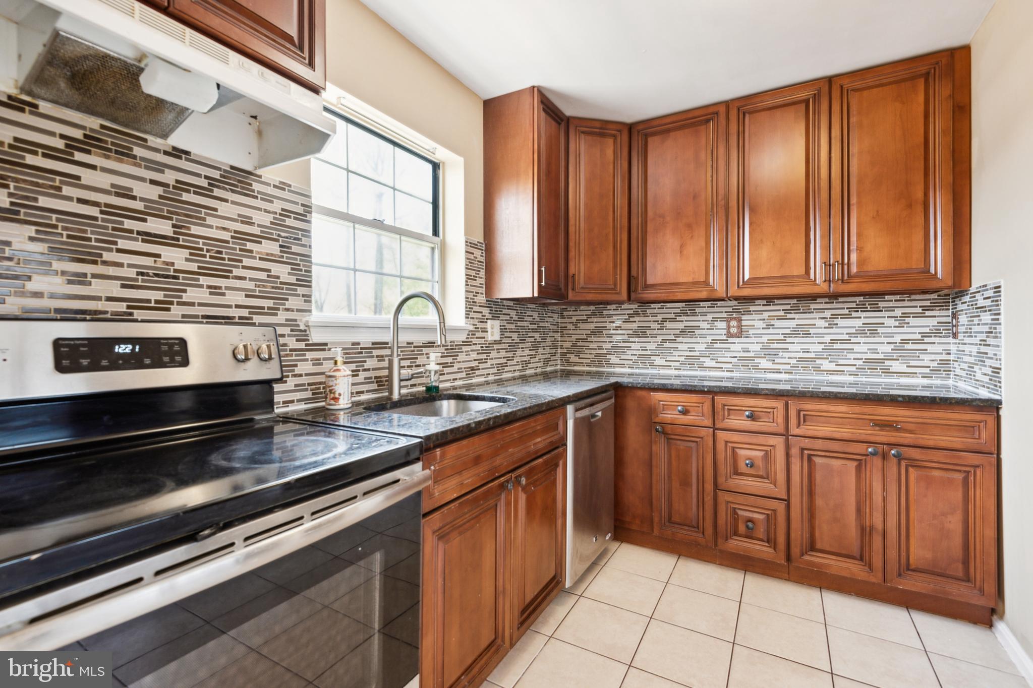795 St Michaels Drive Bowie, MD 20721 - Photo 6 of 25 a kitchen with stainless steel appliances granite countertop a stove sink and cabinets