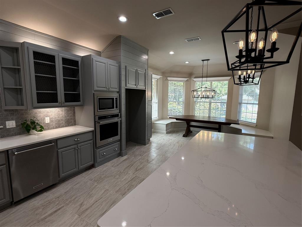 474 Needham Road Pottsboro, TX 75076 - Photo 11 of 40 a open kitchen with stainless steel appliances granite countertop a refrigerator a sink a stove and a wooden floors