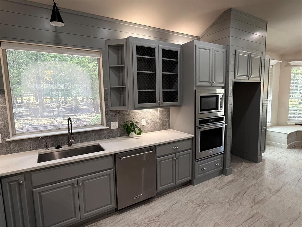 474 Needham Road Pottsboro, TX 75076 - Photo 13 of 40 a kitchen with granite countertop a sink stainless steel appliances and cabinets