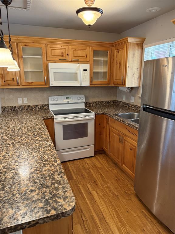 474 Needham Road Pottsboro, TX 75076 - Photo 29 of 40 a kitchen with wooden cabinets and a stove top oven