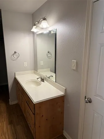 a view of a room with wooden floor fan and window