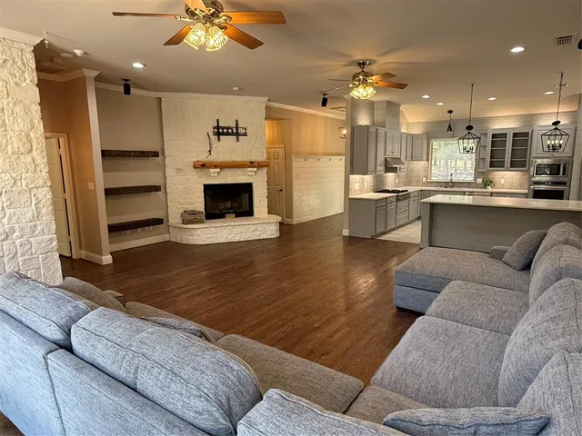 a living room with furniture and kitchen view