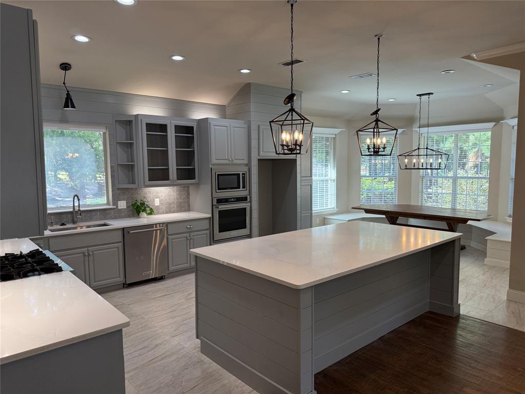 474 Needham Road Pottsboro, TX 75076 - Photo 8 of 40 a large kitchen with kitchen island a large island in it