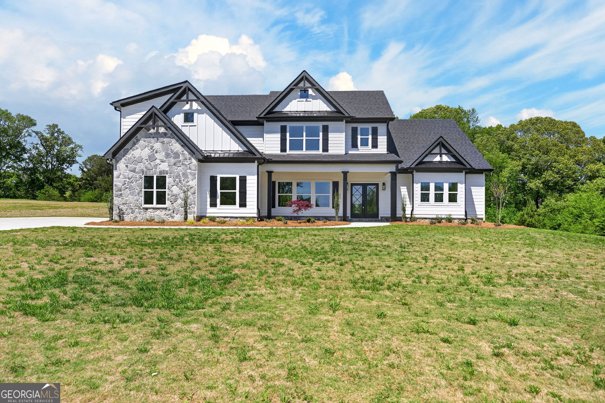a front view of a house with a garden