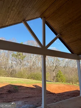 a view of a room with wooden floor and a yard