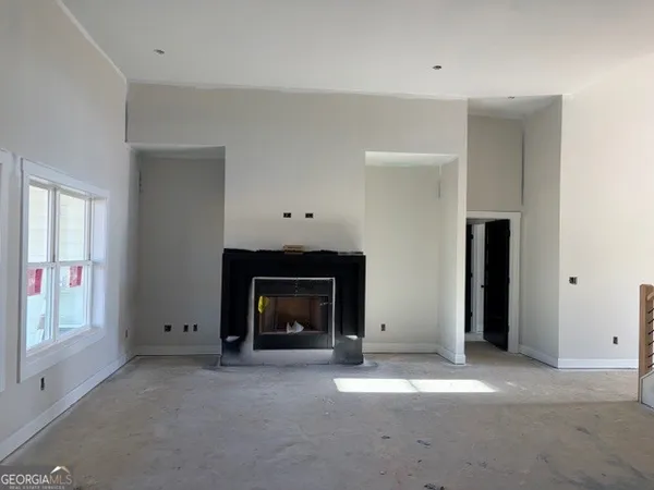 a view of empty room with a fireplace