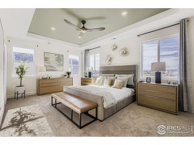 a spacious bedroom with a bed and a chandelier