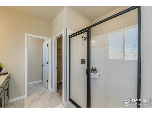 a bathroom with a glass shower door