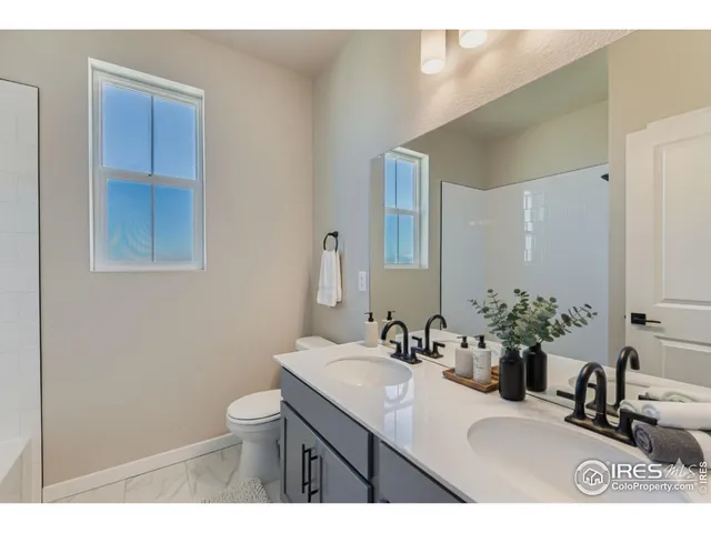 a bathroom with a sink vanity granite and a mirror