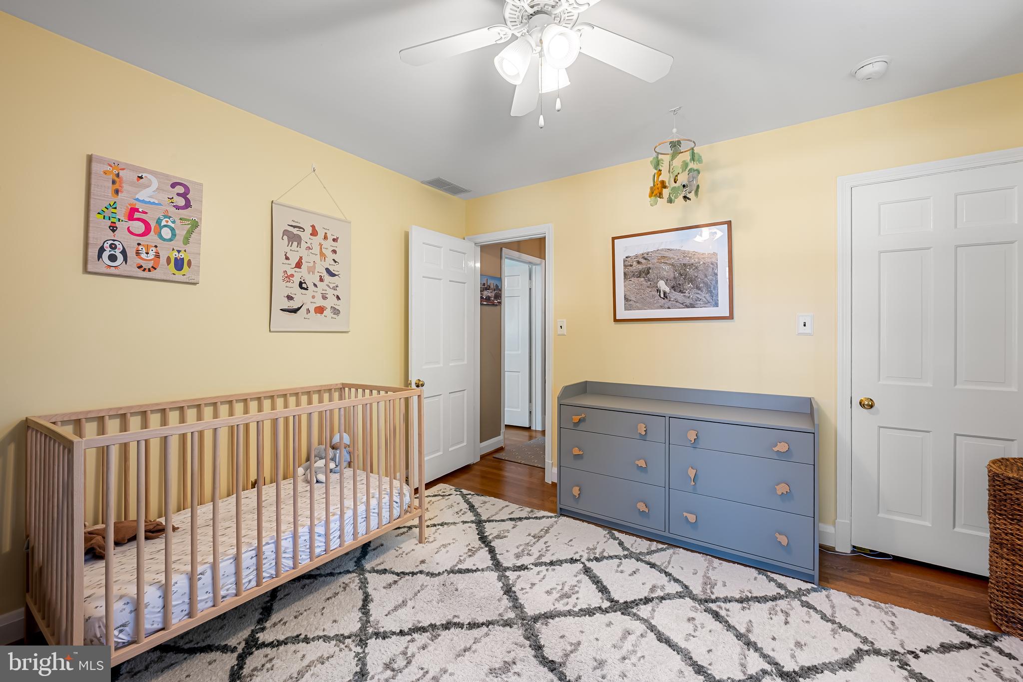 515 Yarmouth Road Baltimore, MD 21286 - Photo 22 of 44 a spacious bedroom with a bed and a chandelier