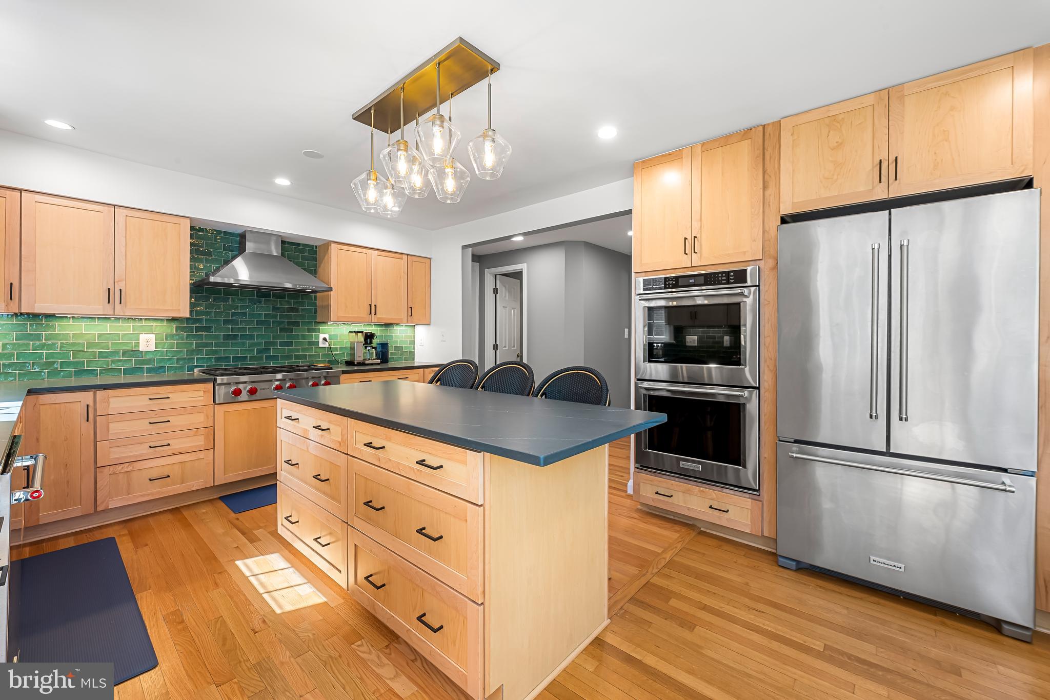 515 Yarmouth Road Baltimore, MD 21286 - Photo 3 of 44 a kitchen with stainless steel appliances granite countertop a refrigerator a stove and a sink with wooden floor