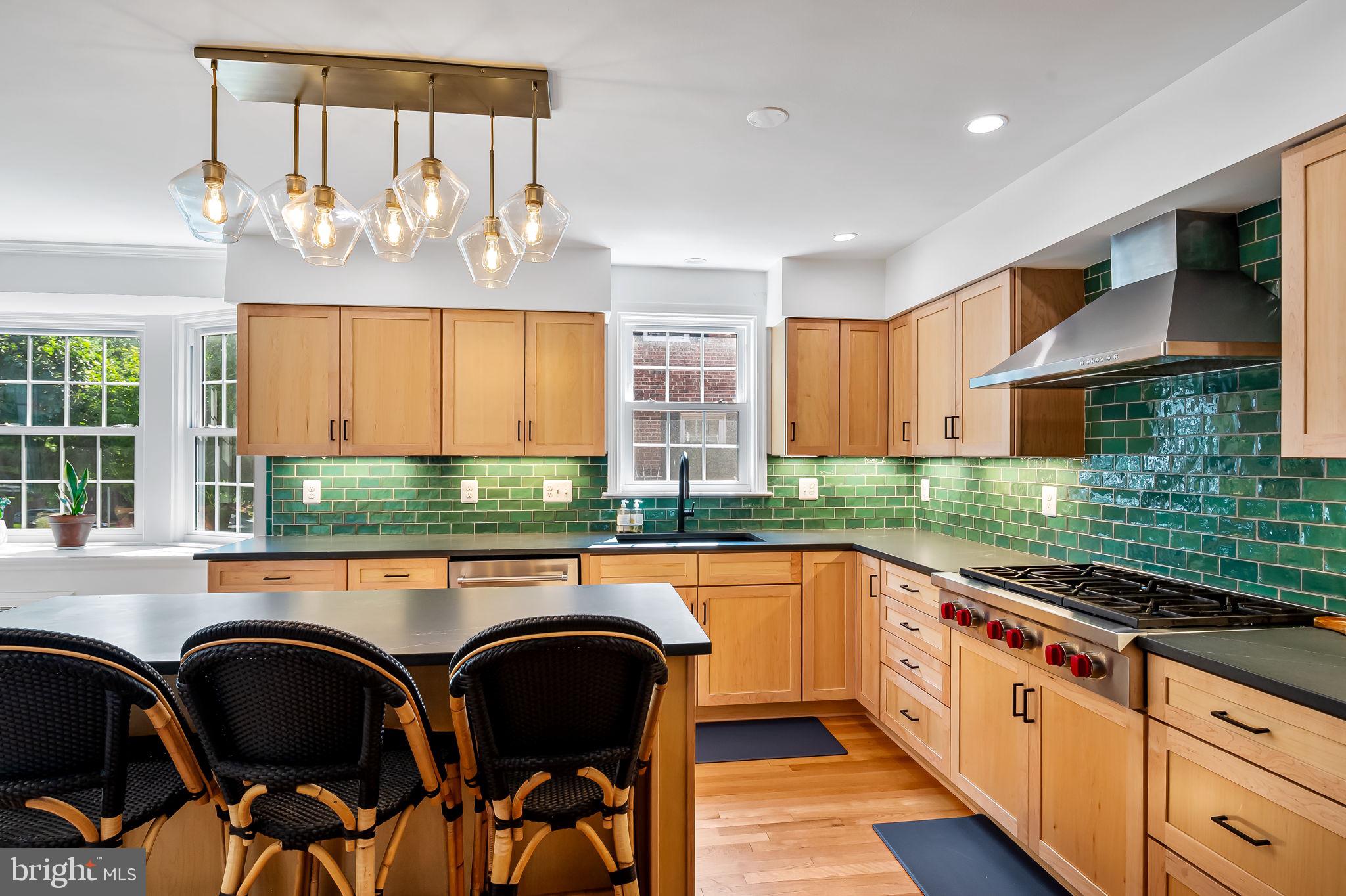 515 Yarmouth Road Baltimore, MD 21286 - Photo 5 of 44 a kitchen with granite countertop a stove a sink and chairs