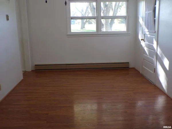 an empty room with a empty space and windows