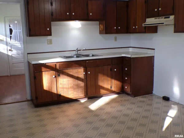 a kitchen with wooden cabinets and a sink