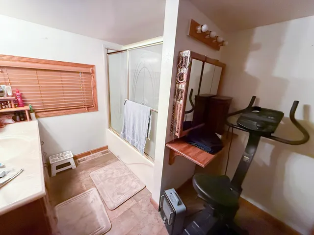 a wooden bench sitting on top of a wooden floor