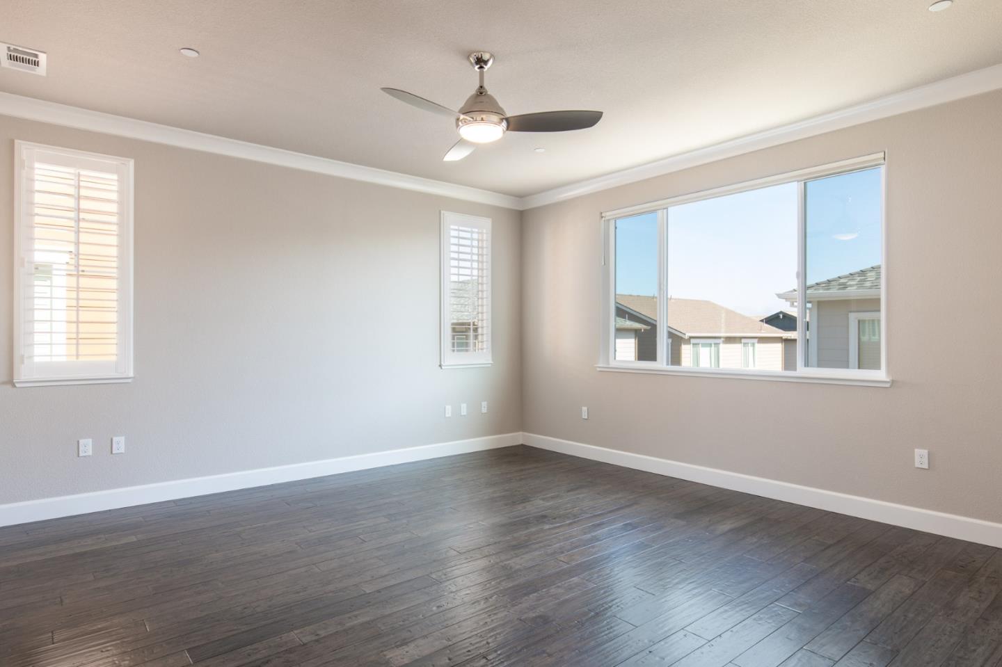 275 10th Street Marina, CA 93933 - Photo 12 of 25 a view of an empty room with wooden floor and a window