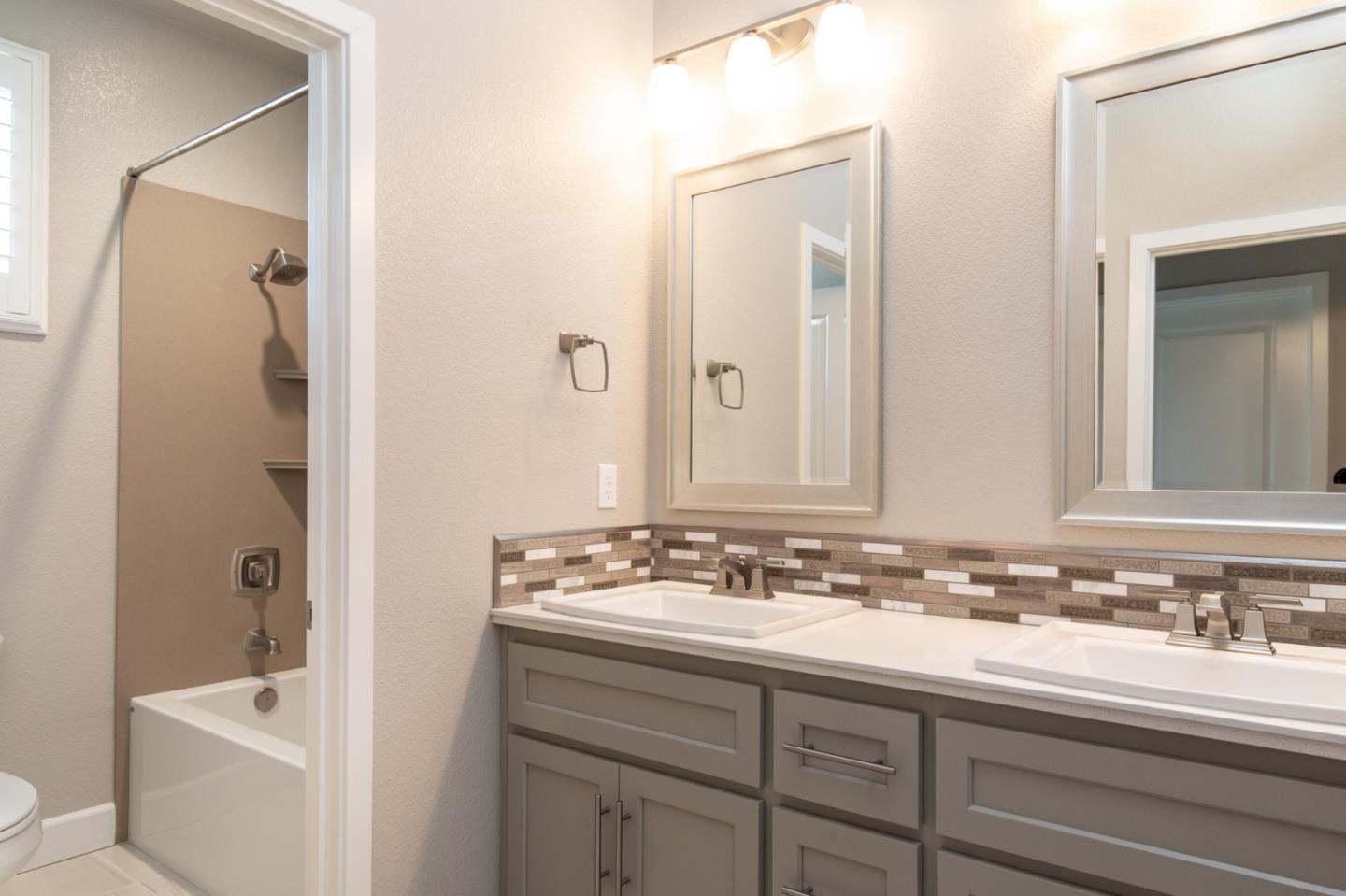 275 10th Street Marina, CA 93933 - Photo 19 of 25 a bathroom with a sink and a mirror