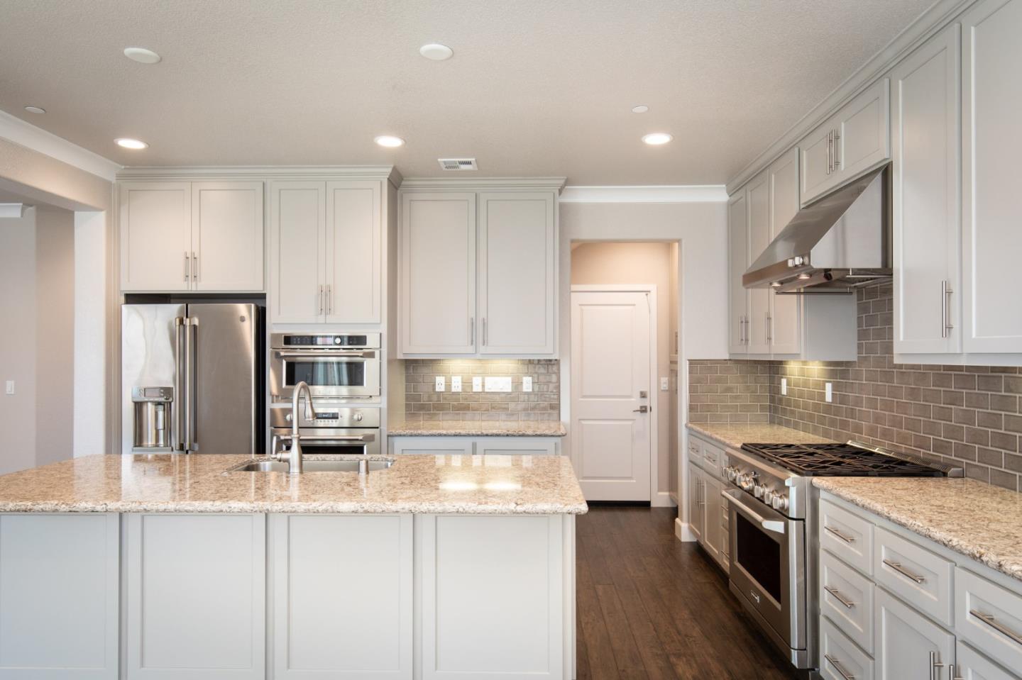 275 10th Street Marina, CA 93933 - Photo 6 of 25 a kitchen with stainless steel appliances granite countertop a refrigerator and a stove top oven