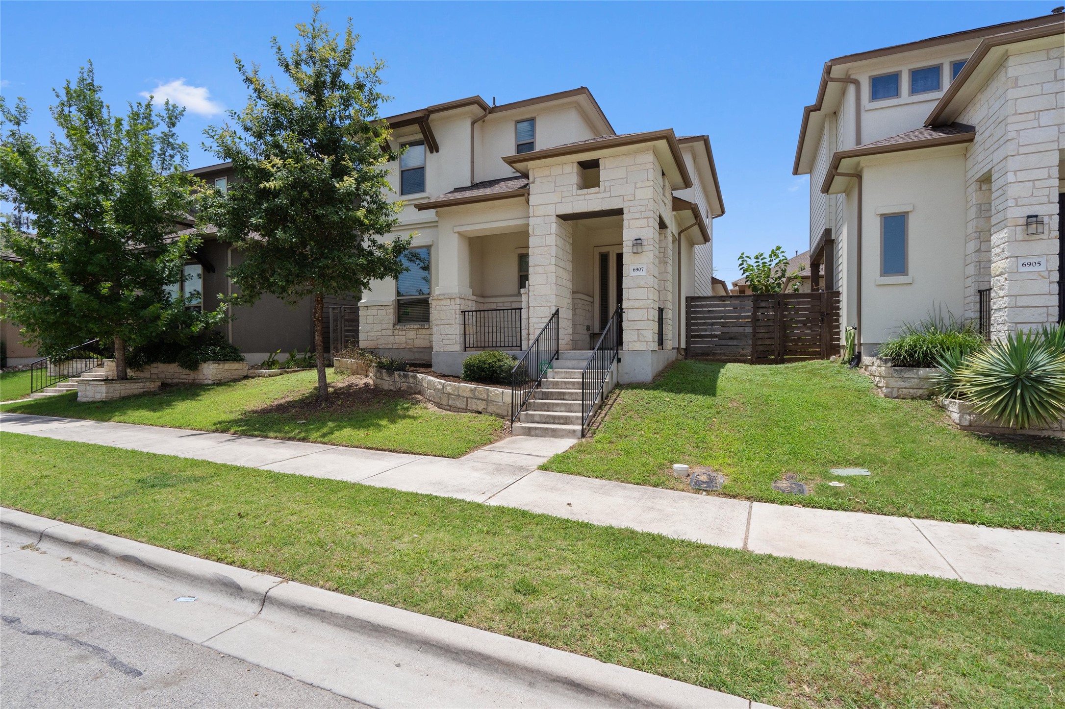 6907 Idea Road Austin, TX 78741 - Photo 2 of 36 a view of a white house with a yard and plants