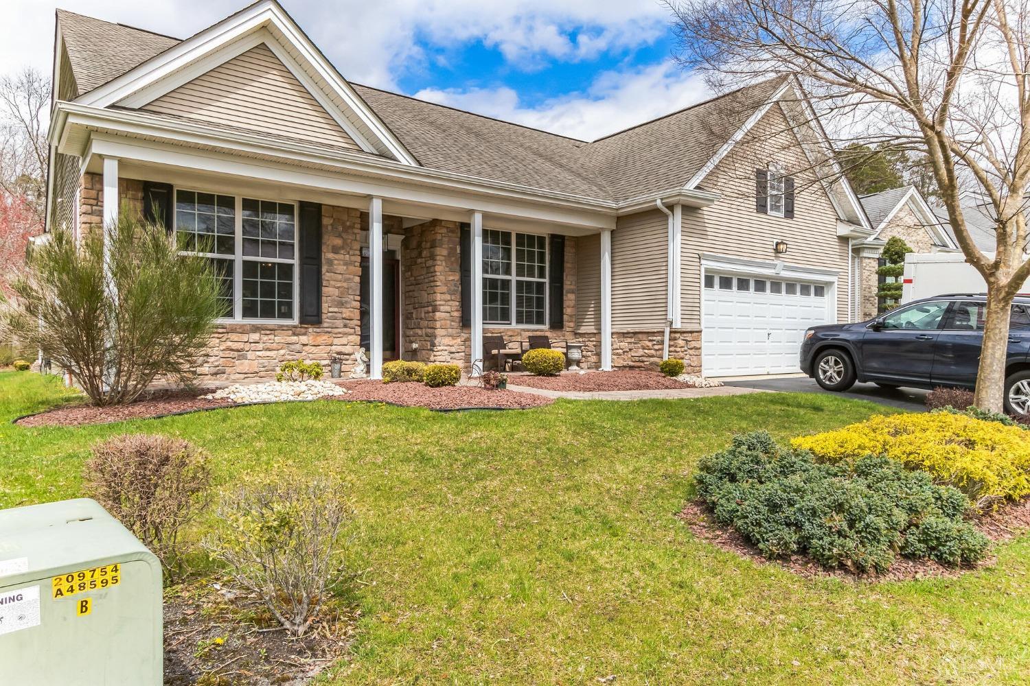 22 Park Ridge Way Jackson, NJ 08527 - Photo 3 of 38 a front view of a house with a garden and patio